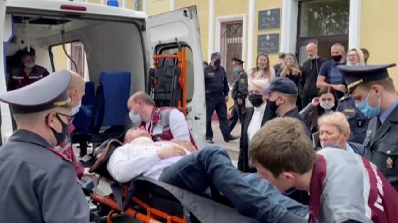 A still image taken from video footage shows Latypov being carried out of a court building in Minsk.