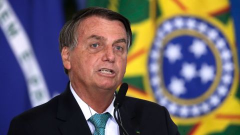 Brazil's President Jair Bolsonaro confirms his country to host the 2021 Copa America soccer tournament, during a ceremony of the state bank sponsoring Brazilian athletics, at the Planalto presidential palace, in Brasilia, Brazil, Tuesday, June 1, 2021. (AP Photo/Eraldo Peres)