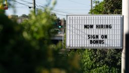 A "Now Hiring" sign outside a business in Lithonia, Georgia, U.S., on Monday, April 26, 2021. The U.S. economy is on a multi-speed track as minorities in some cities find themselves left behind by the overall boom in hiring, according to a Bloomberg analysis of about a dozen metro areas. Photographer: Elijah Nouvelage/Bloomberg via Getty Images