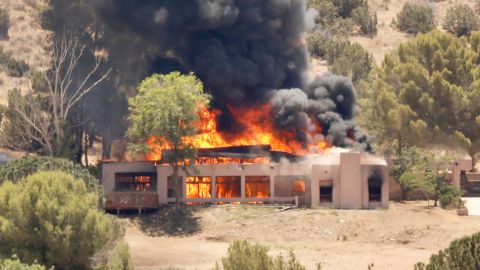 A home burns in the 2600 block of W. Bent Spur Drive in Acton, California, on Tuesday, June 1, 2021.