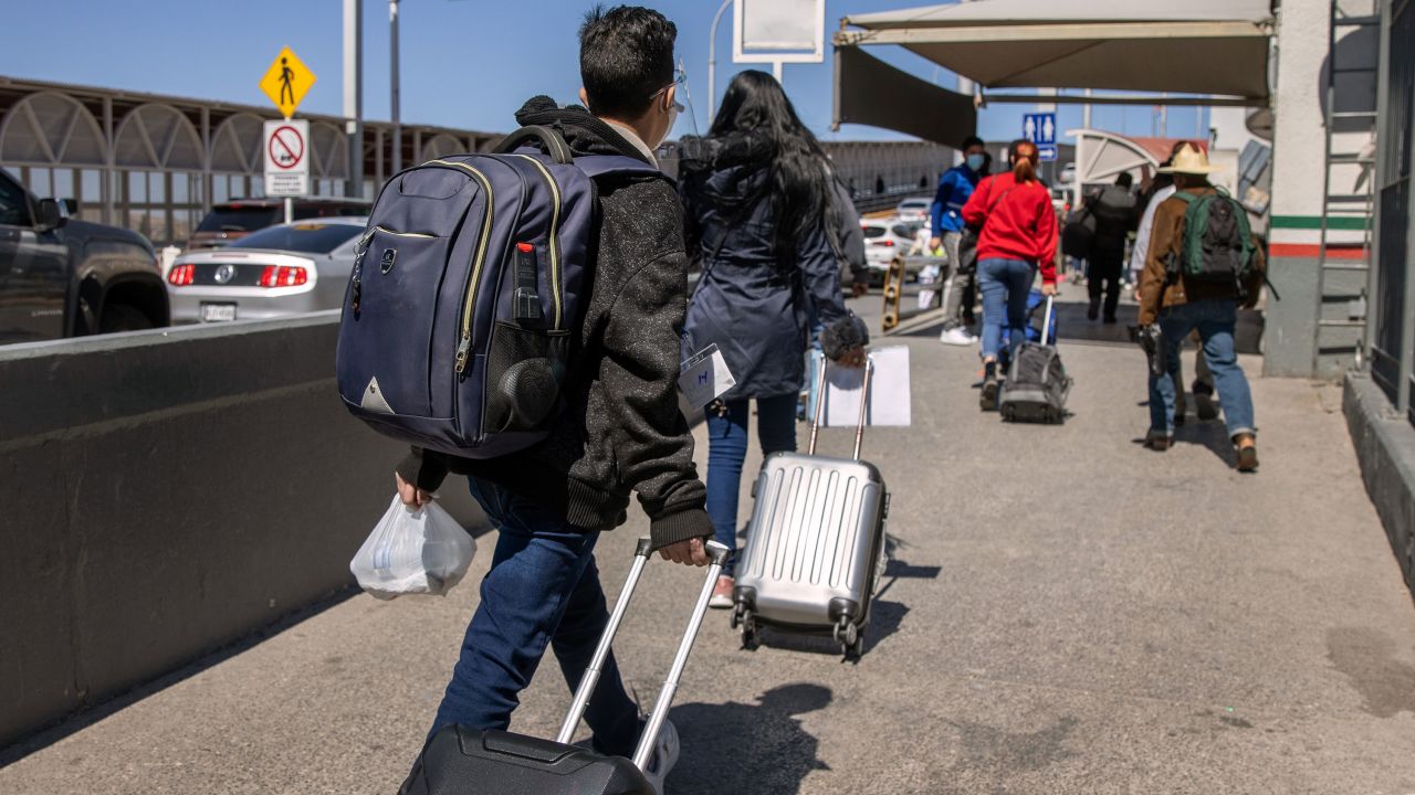 Asylum seekers cross an international bridge from Mexico into the United States on March 17, 2021, in Ciudad Juarez, Mexico. 