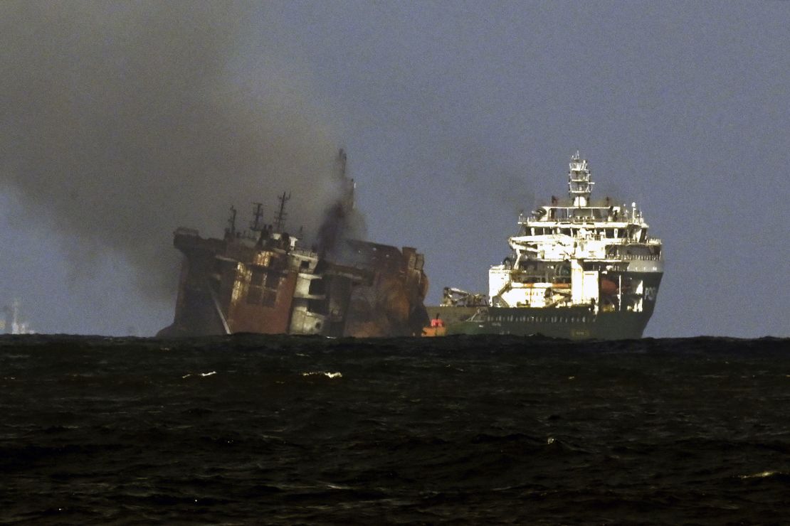 A tugboat from the Dutch salvage firm SMIT tows the fire stricken Singapore-registered container ship MV X-Press Pearl away from the coast of Colombo on June 2.
