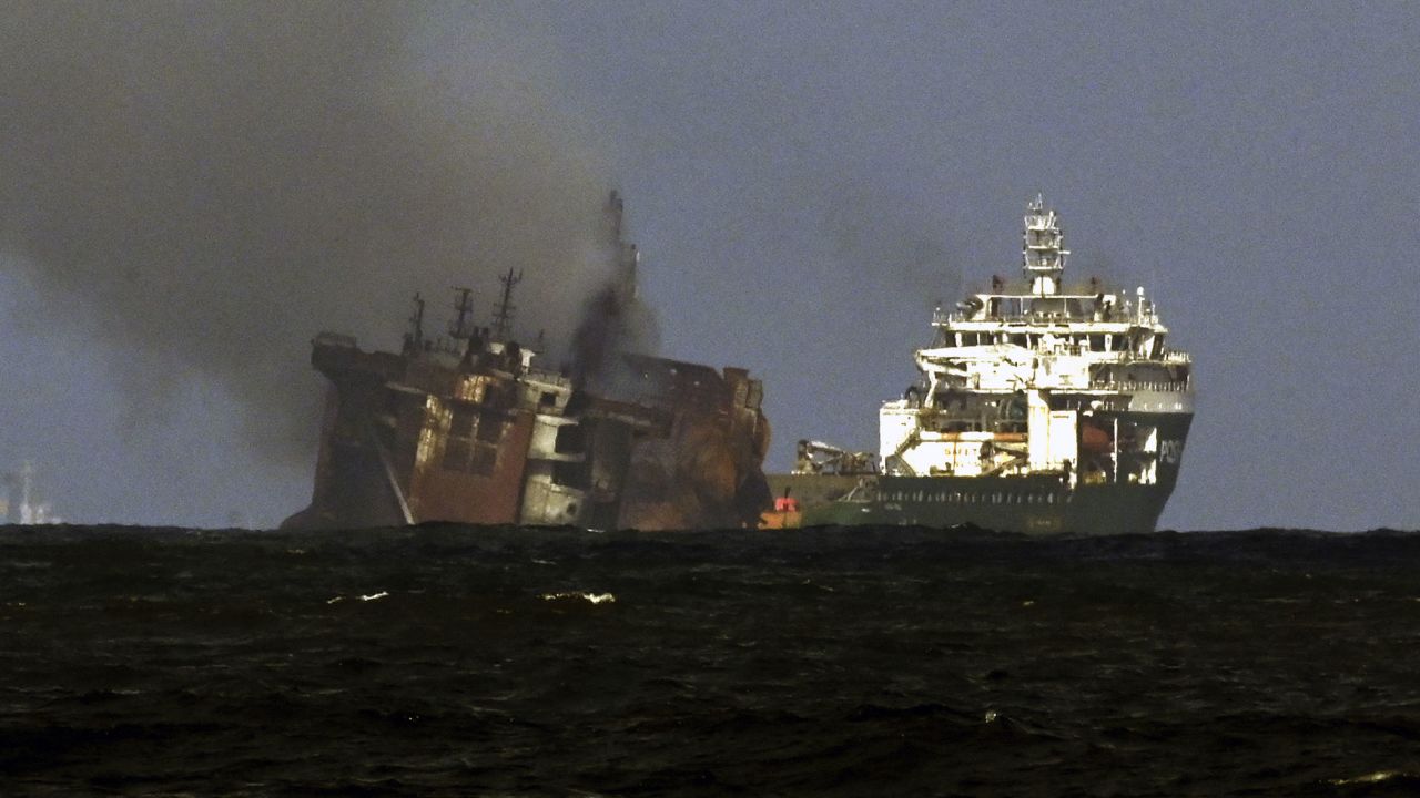 A tugboat from the Dutch salvage firm SMIT tows the fire stricken Singapore-registered container ship MV X-Press Pearl away from the coast of Colombo on June 2.
