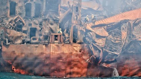 Salvors manage to board the stricken ship to assess the damage after fire had been successfully doused for the first time since May 20.