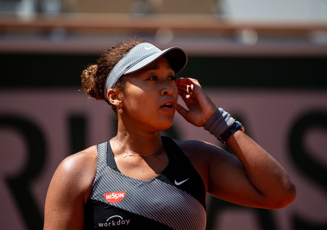 Osaka looks to her team during her match against Patricia Maria Țig at Roland Garros.