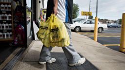 A customer exits a Dollar General Corp. store in Colona, Illinois, U.S., on Wednesday, Sept. 10, 2014. Dollar General Corp., spurned twice in attempts to buy Family Dollar Stores Inc., took its $9.1 billion offer directly to shareholders in a hostile bid. Photographer: Daniel Acker/Bloomberg via Getty Images