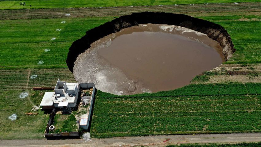 Aerial view of a sinkhole that was found by farmers in a field of crops in Santa Maria Zacatepec, state of Puebla, Mexico on June 01, 2021. (Photo by JOSE CASTAÑARES / AFP) (Photo by JOSE CASTANARES/AFP via Getty Images)