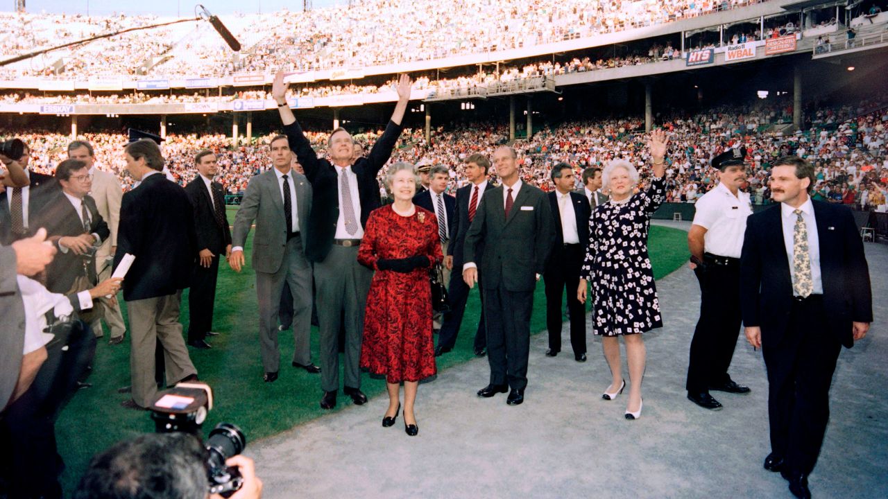 US President George Bush (C), Britain's Queen Elizabeth II (C), Prince Philip, Duke of Edinburgh (4th R) and Barbara Bush (3rd R) wave to the crowd before the start of the Orioles vs. the Oakland Athletics baseball game at the Memorial Stadium in Baltimore on May 15, 1991.