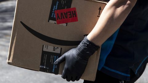 An Amazon delivery woman delivers packages amid the coronavirus pandemic in Los Angeles, California, in March 2020. 