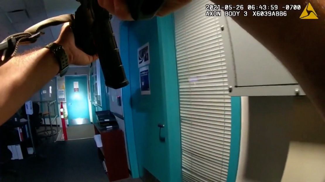 An officer reacts after hearing a shot from another room at the VTA building on May 26. Officers would find Cassidy's body beyond the double doors at the end of this passage, on the right side.