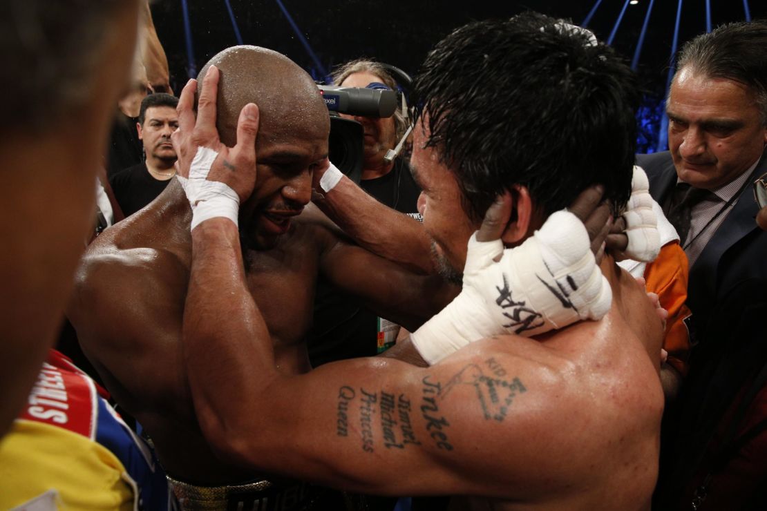 Mayweather hugs Manny Pacquiao after defeating him in their welterweight unification bout.