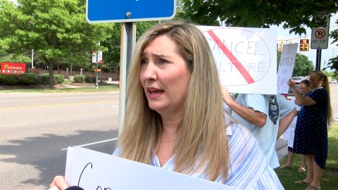 Amy Facchinello takes part in protests supporting her before a school board meeting.