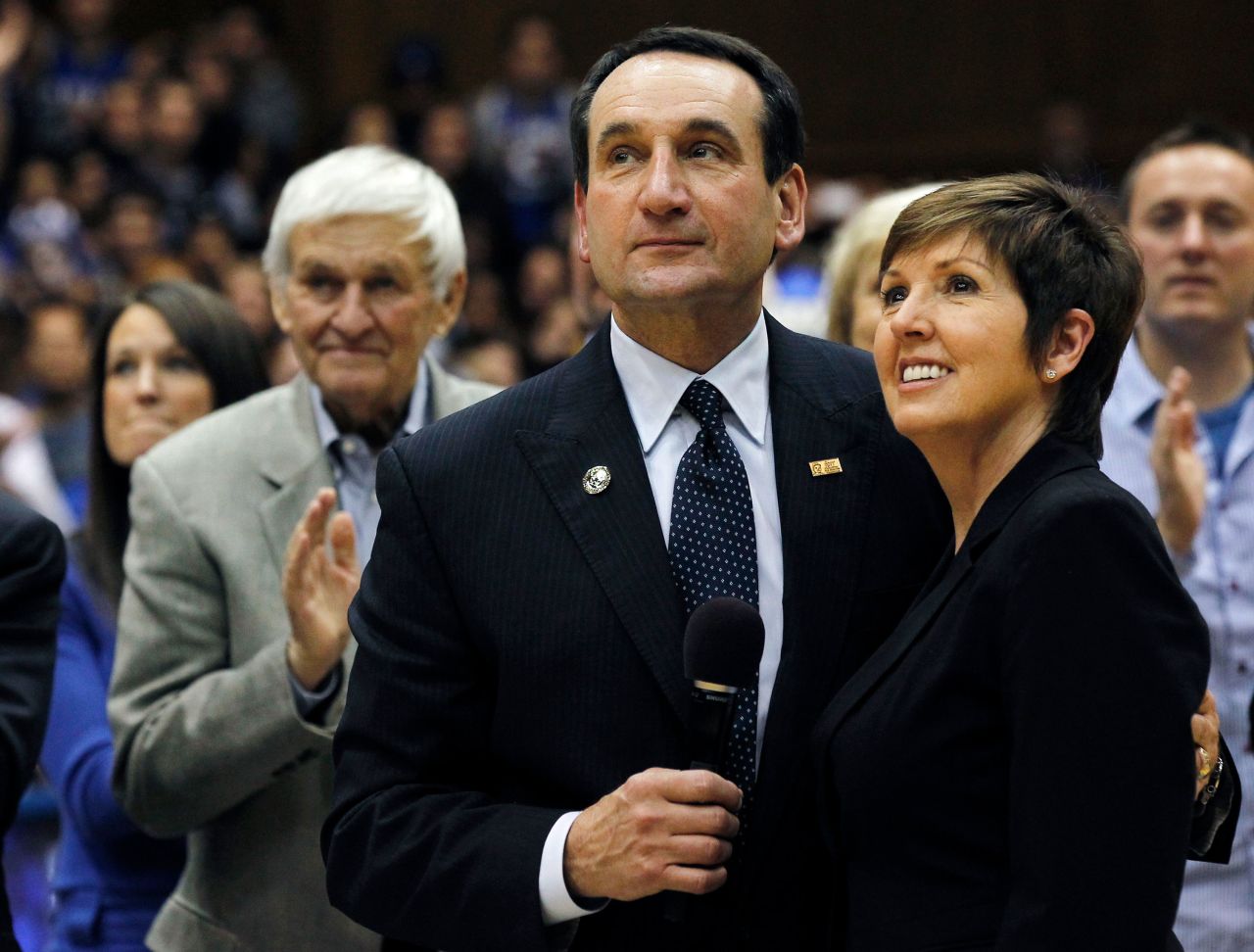 Krzyzewski and his wife, Mickie, watch as a new banner, celebrating his wins record, is unveiled at Cameron Indoor Stadium. On the left is former Duke athletic director Tom Butters, who hired Krzyzewski.