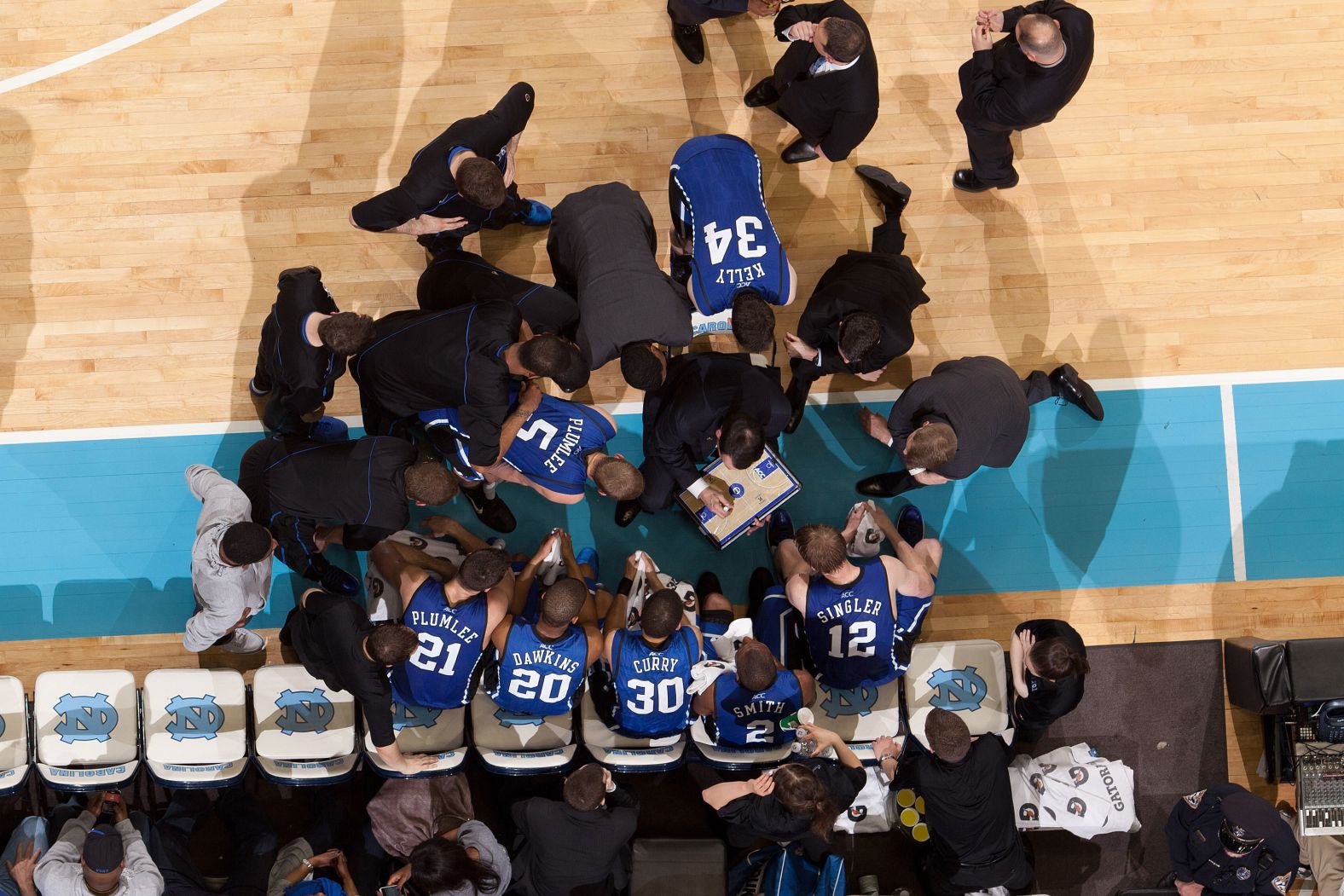 Krzyzewski coaches his team during a huddle in 2011.