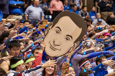 Duke fans hold up a cardboard cutout of Krzyzewski's face during a game in 2019.