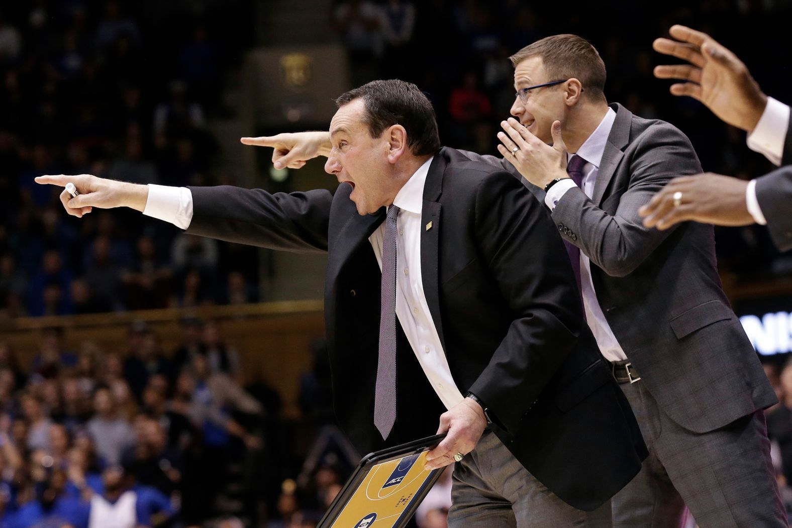 Krzyzewski directs his team as associate head coach Jon Scheyer shouts behind him in 2019. Scheyer will succeed Krzyzewski as Duke's next head coach. Scheyer also played for Krzyzewski and was on the national title team in 2010.