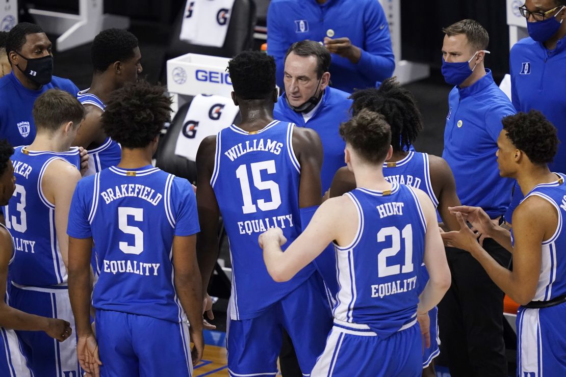 Duke head coach Mike Krzyzewski, top, talks to his team during the first half of an NCAA college basketball game against Louisville on Wednesday, March 10, 2021. 
