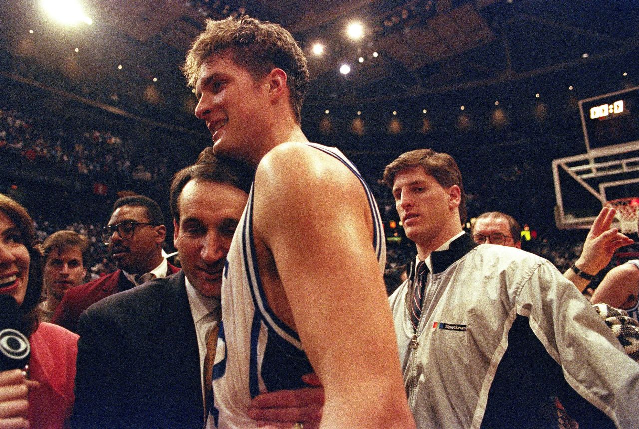Krzyzewski hugs his star center, Christian Laettner, after Laettner's buzzer-beater over Kentucky put the Blue Devils in the 1992 Final Four. Duke went on to repeat as champions.