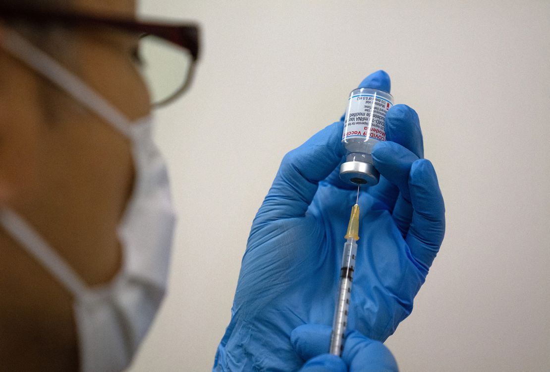 Staff prepare Moderna coronavirus vaccines for use at a newly opened mass vaccination centre in Tokyo on May 24.