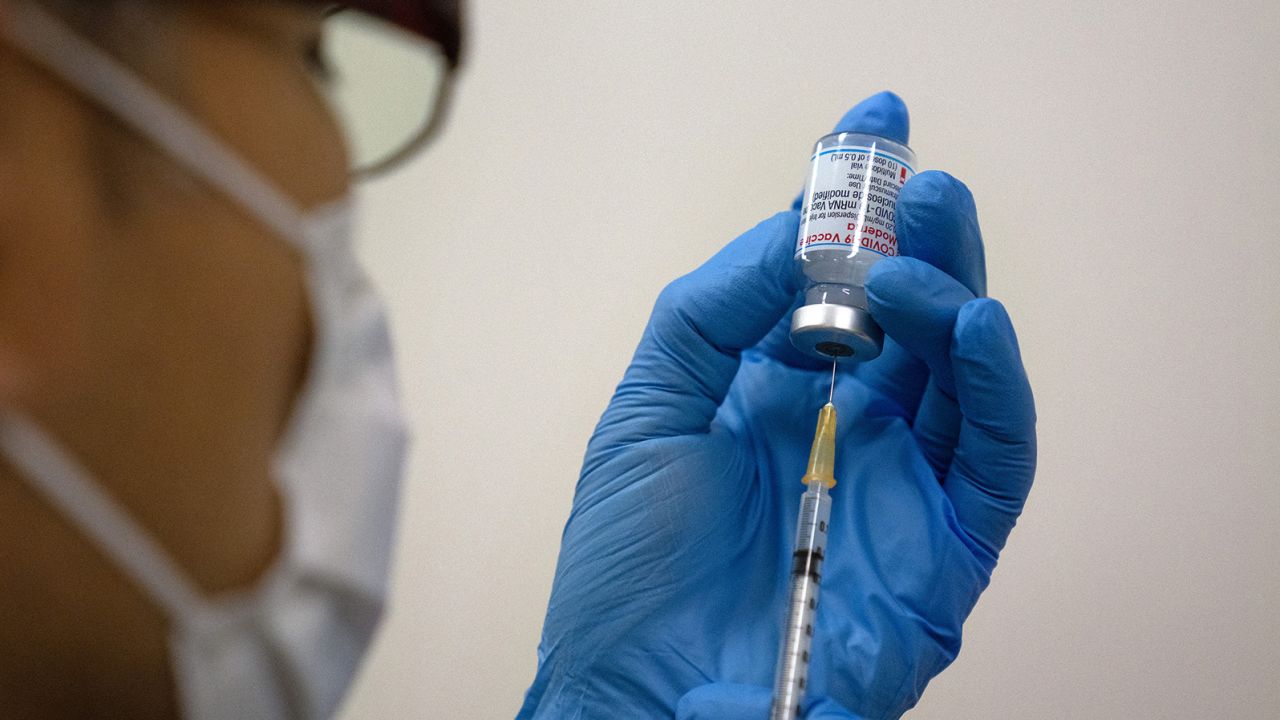 Medical staff prepare Moderna coronavirus vaccines for use at the newly-opened mass vaccination centre in Tokyo on May 24, 2021. (Photo by Carl Court / POOL / AFP) (Photo by CARL COURT/POOL/AFP via Getty Images)