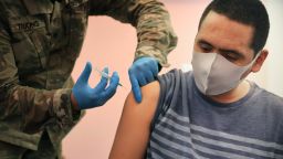 WHEATON, MARYLAND - MAY 21: Maryland National Guard Specialist James Truong (L) administers a Moderna coronavirus vaccine at CASA de Maryland's Wheaton Welcome Center on May 21, 2021 in Wheaton, Maryland. The mobile vaccination clinic was staffed with members of the Maryland National Guard and part of the Maryland Vaccine Equity Task Force, which works with local health departments and community organizations to focus COVID-19 vaccination efforts on "underserved, vulnerable, and hard-to-reach populations." (Photo by Chip Somodevilla/Getty Images)