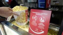 FRANKLIN, TENNESSEE - AUGUST 20: A customer is seen buying popcorn at AMC DINE-IN Thoroughbred 20 on August 20, 2020 in Franklin, Tennessee. AMC Theaters reopened more than 100 of its movie theaters across the United States today for the first time since closing in March because of the coronavirus (COVID-19) pandemic with a 15-cent ticket price promotion and new safety precautions in place.  According to AMC, enhanced cleaning and safety protocols include disinfecting theaters before each show, mandatory face coverings for employees and customers, upgraded air filtration systems where possible, and high-touch points cleaned throughout the day. Hand sanitizer and disinfectant wipes are available throughout the theaters, auditoriums are at 40 percent capacity or less. (Photo by Jason Kempin/Getty Images)