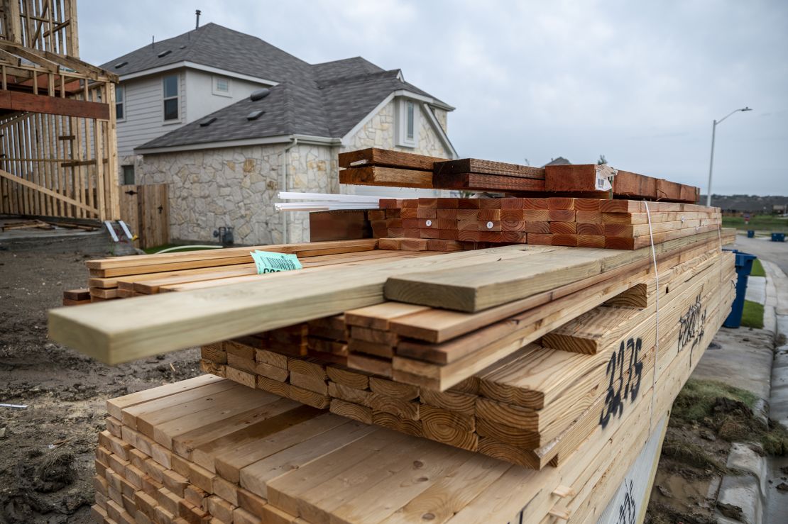 Piles of lumber outside a home under construction in the CastleRock Communities Sunfield residential development in Texas.