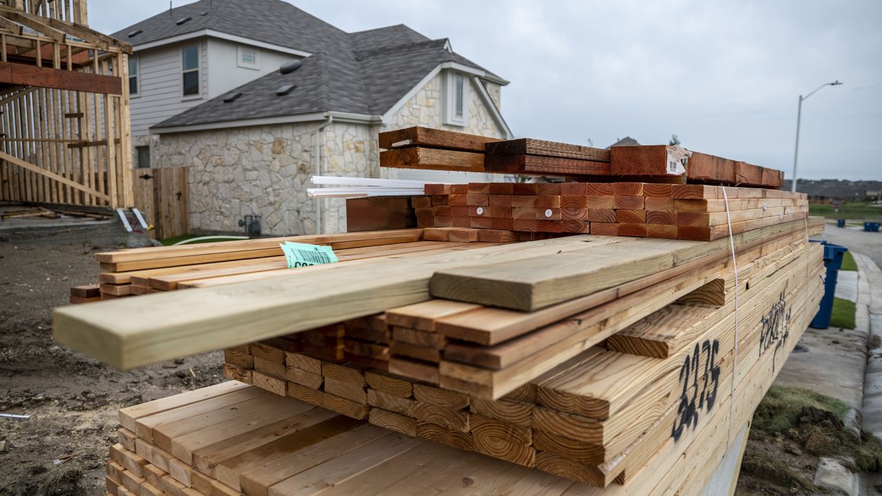 Piles of lumber outside a home under construction in the CastleRock Communities Sunfield residential development in Texas.