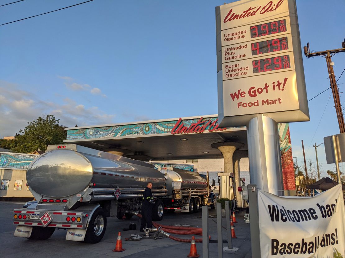 A truck driver checks the gasoline tank level at a United Oil gas station in Sunset Blvd., Los Angeles on May 20.