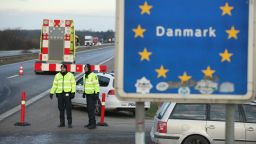 PADBORG, DENMARK - JANUARY 06:  Danish police conducting spot checks on incoming traffic from Germany stand at the A7 highway border crossing on January 6, 2016 near Padborg, Denmark. Denmark introduced a 10-day period of passport controls and spot checks yesterday on its border to Germany in an effort to stem the arrival of refugees and migrants seeking to pass through Denmark on their way to Sweden. Denmark reacted to border controls introduced by Sweden the same day and is seeking to avoid a backlog of migrants accumulating in Denmark. Refugees still have the right to apply for asylum in Denmark and those caught without a valid passport or visa who do not apply for asylum are sent back to Germany.  (Photo by Sean Gallup/Getty Images)