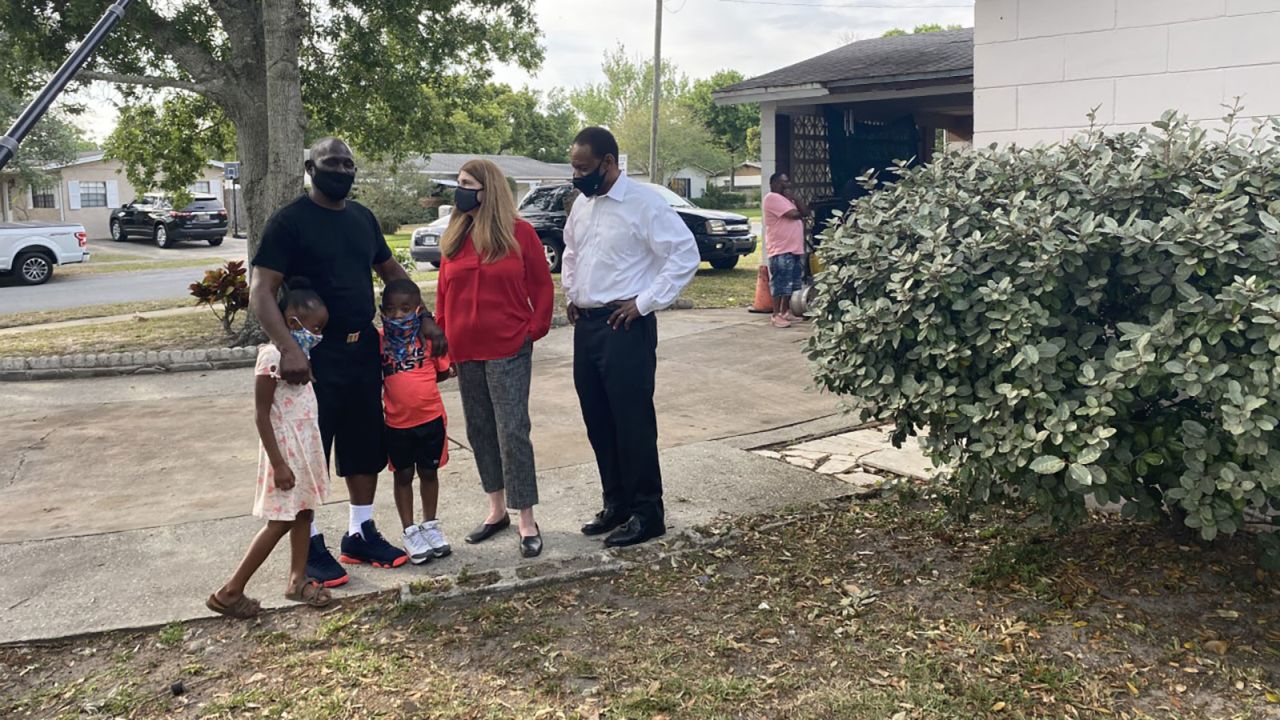 Green talks to Thomas and Harrison while holding two of his grandchildren close.