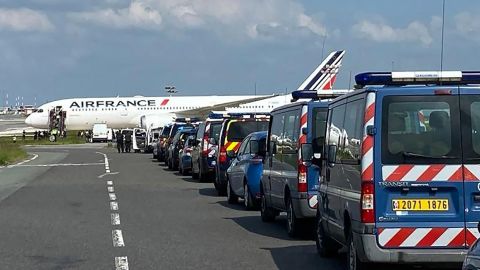 A handout photo from the Gendarmerie Nationale shows its officers and airport police on the runway of Charles de Gaulle airport.