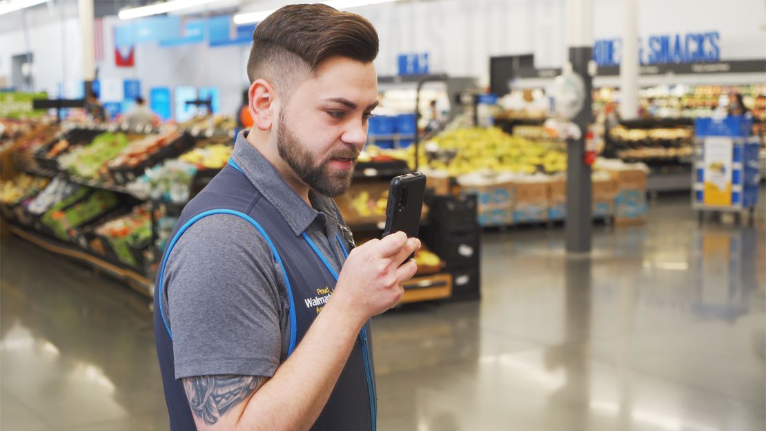 Walmart employee using the new phone.