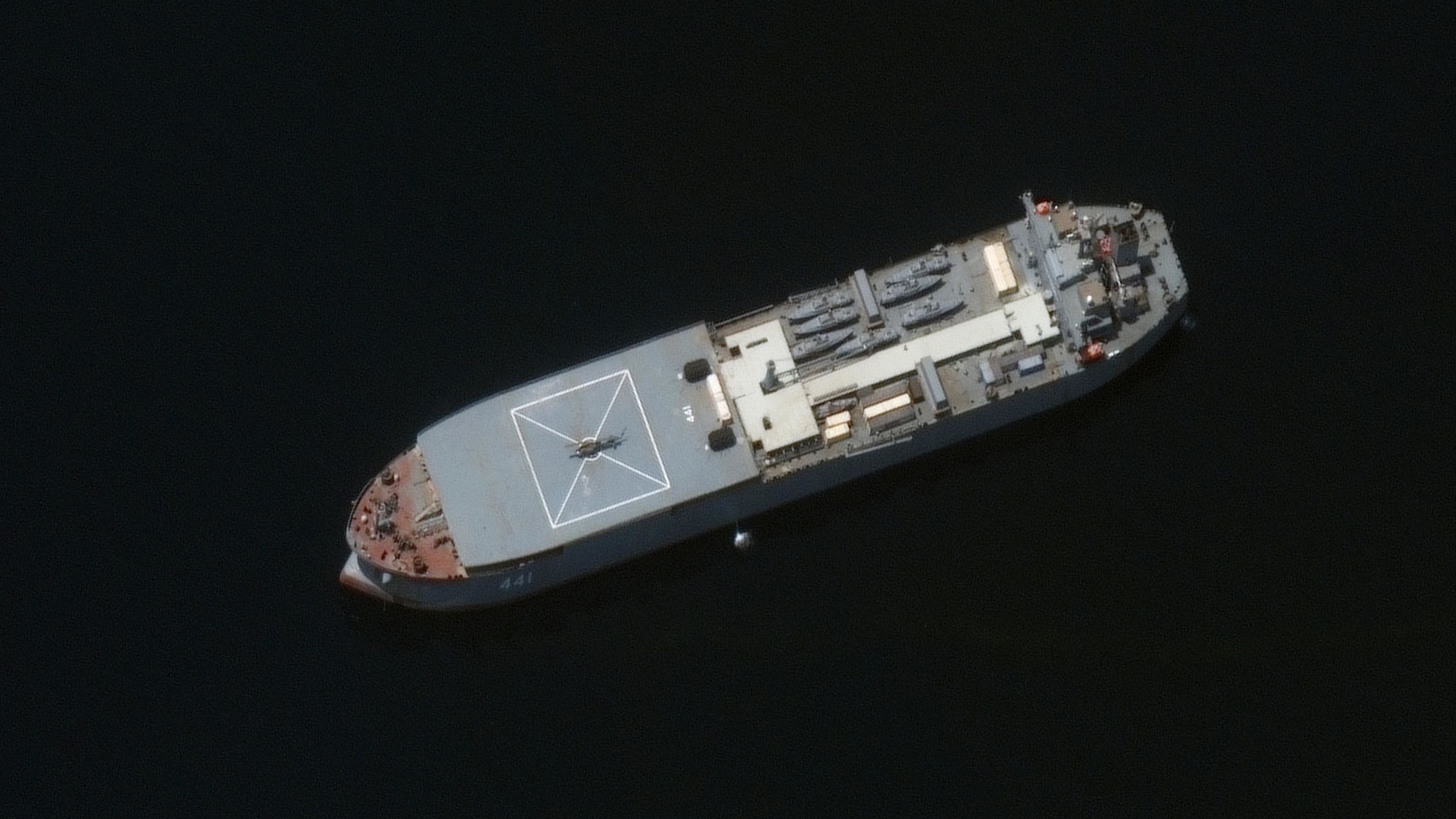 The Iranian ship Makran is seen in this Maxar Technologies satellite image from early May in the Persian Gulf around Larak Island. The vessel appears to be loaded with seven small fast-attack boats on its deck. 