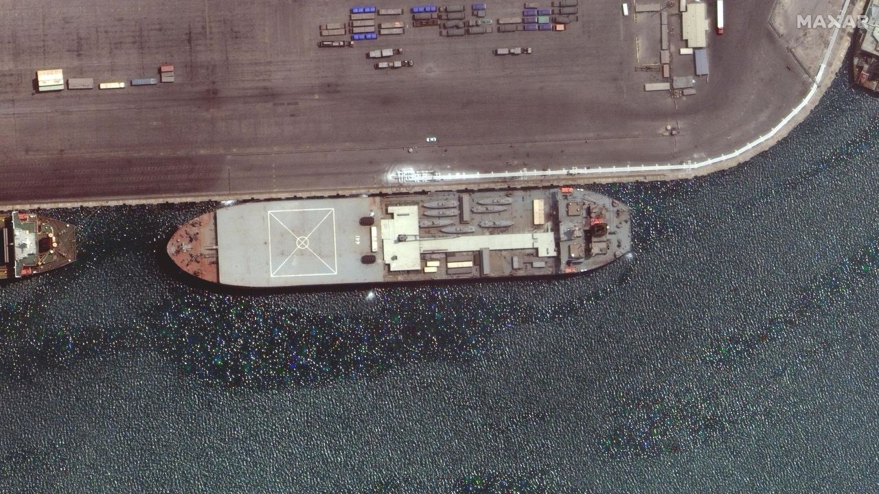 The Iranian ship Makran is seen in this Maxar Technologies satellite image from late April docked in the Iranian port of Bandar Abbas. The boat appears to be loaded with seven small fast-attack boats on its deck.