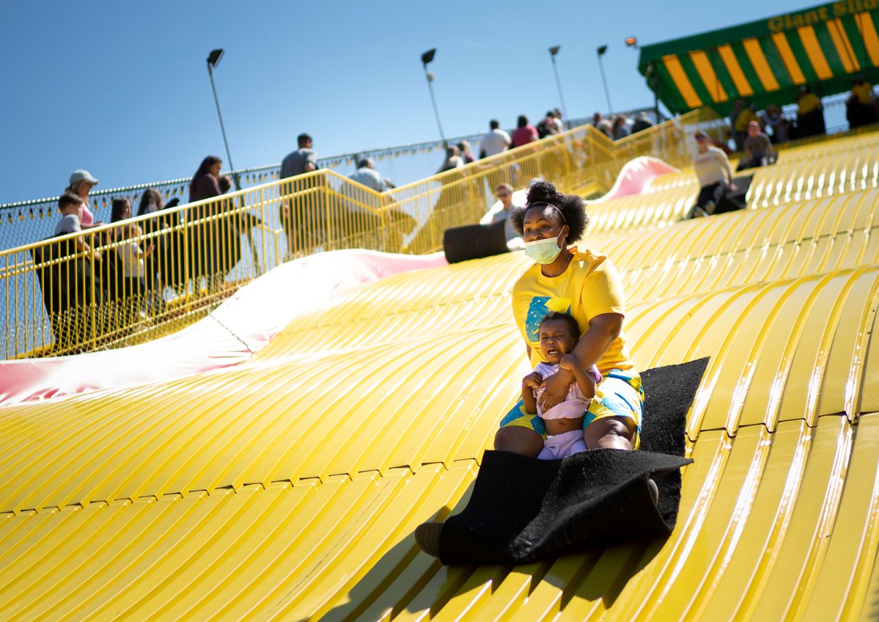 Shawnda Henderson rides a giant slide with her daughter Mira at the Minnesota State Fairgrounds in Falcon Heights on Monday, May 31.