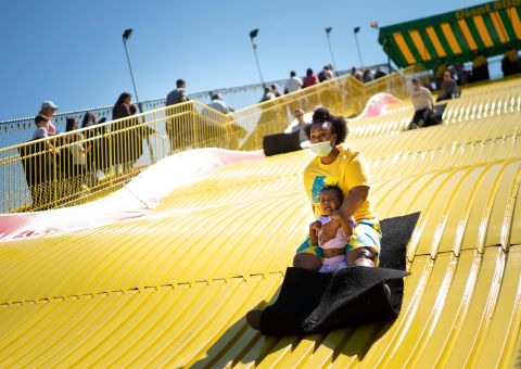 Shawnda Henderson rides a giant slide with her daughter Mira at the Minnesota State Fairgrounds in Falcon Heights on Monday, May 31.
