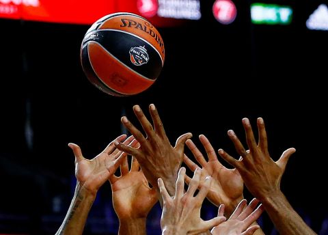 Players reach for the ball during a EuroLeague Final Four game between Barcelona and Olimpia Milano on Friday, May 28.