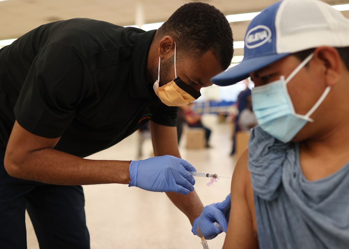 Odilest Guerrier gives a Covid-19 vaccine shot to Pasqual Cruz at a clinic in Immokalee, Florida, on May 20. The decision to get a shot can be a very emotional one for some people.