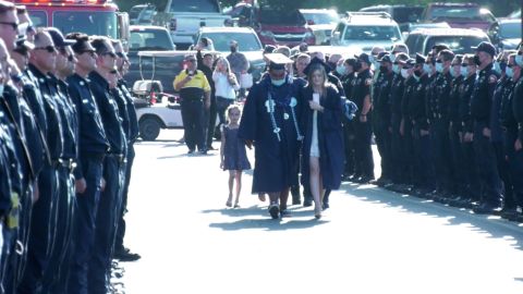 Firefighters line the entrance to Thursday's graduation ceremony as Joslyn Carlon and her family walked in.