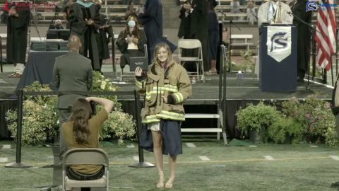 Joslyn Carlon received her diploma while wearing her late father's firefighting jacket.