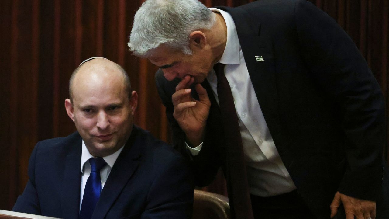 Right-wing Bennett described centrist Yair Lapid (R), his new coalition partner, as his friend.