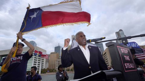 In this November 2020 file photo, Texas GOP chairman Allen West, right, speaks to supporters of President Donald Trump during a rally in front of City Hall in Dallas. 