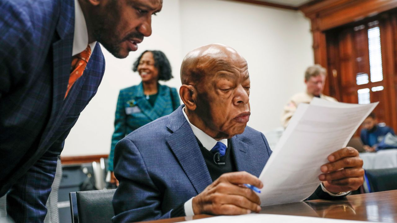 Congressman John Lewis read paperwork to qualify for reelection to his District 5 seat in Atlanta, Monday, March 2, 2020. 