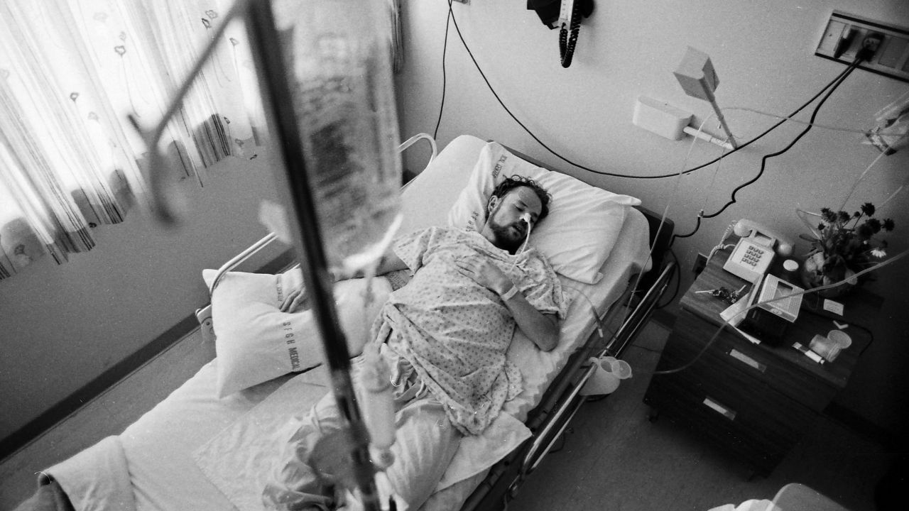 Deotis McMather is pictured asleep in bed at the San Francisco General Hospital's Ward 5B -- the first AIDS hospital unit in the nation. After being diagnosed with AIDS, he returned to his apartment, where all of his belongings had been thrown out onto the street.