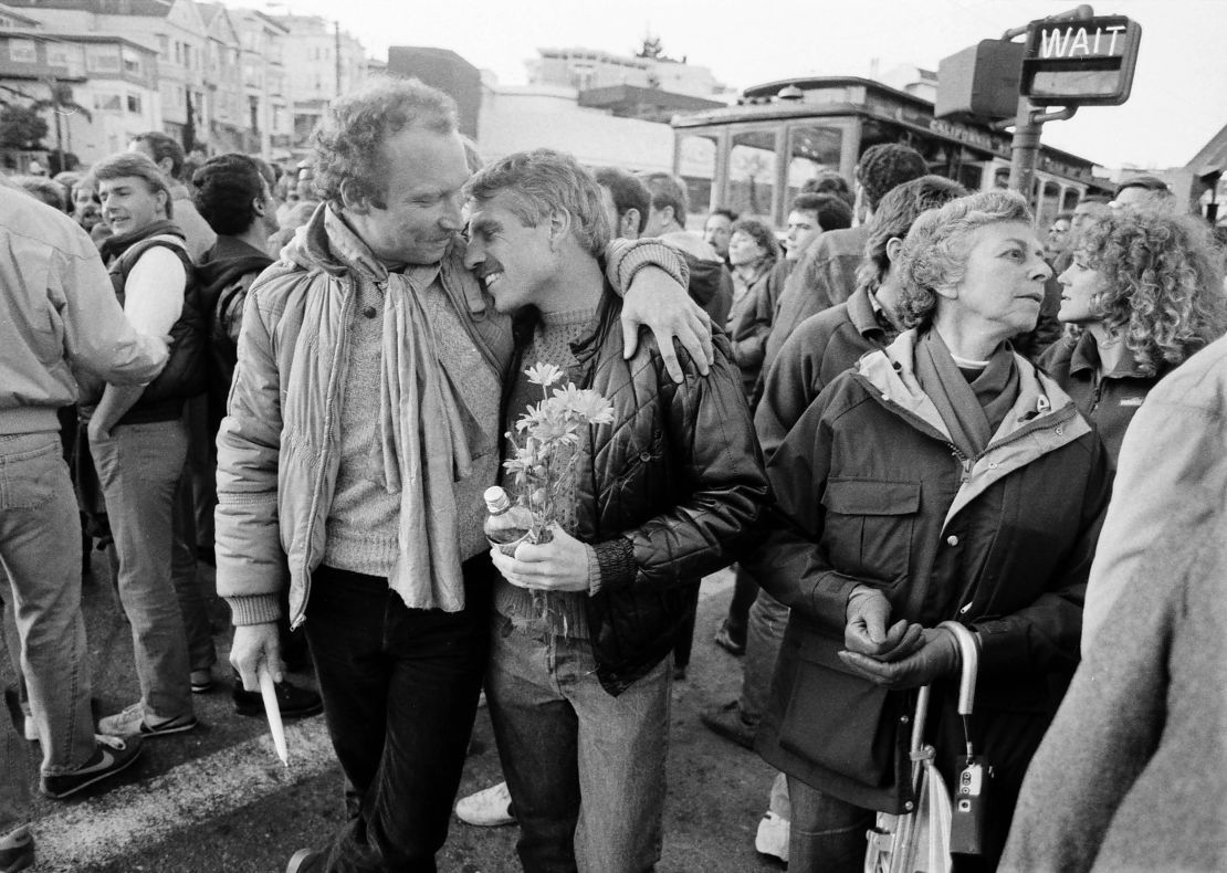 Gary Walsch, who was living with AIDS, leans on a friend's shoulder before a candlelight vigil in San Francisco in 1983. The vigil was held to bring attention to the AIDS crisis affecting the gay community.