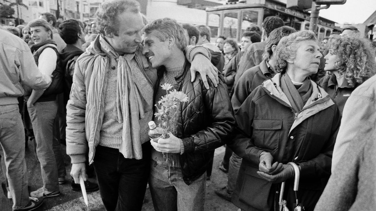 Gary Walsch, who was living with AIDS, leans on a friend's shoulder before a candlelight vigil in San Francisco in 1983. The vigil was held to bring attention to the AIDS crisis affecting the gay community.