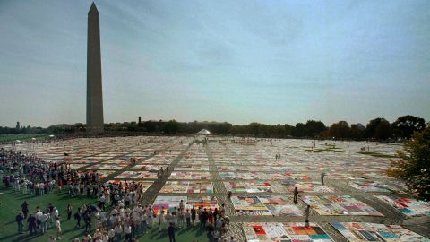 Visitors and volunteers walk on the 21,000-panel AIDS Memorial Quilt on October 10, 1992 in Washington.