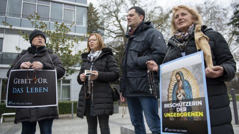 Anti-abortion activists pray during a "40 Days For Life" picket outside the Pro Familia center in Frankfurt, Germany, on March 26, 2019. The state-approved center offers consultations on abortions.