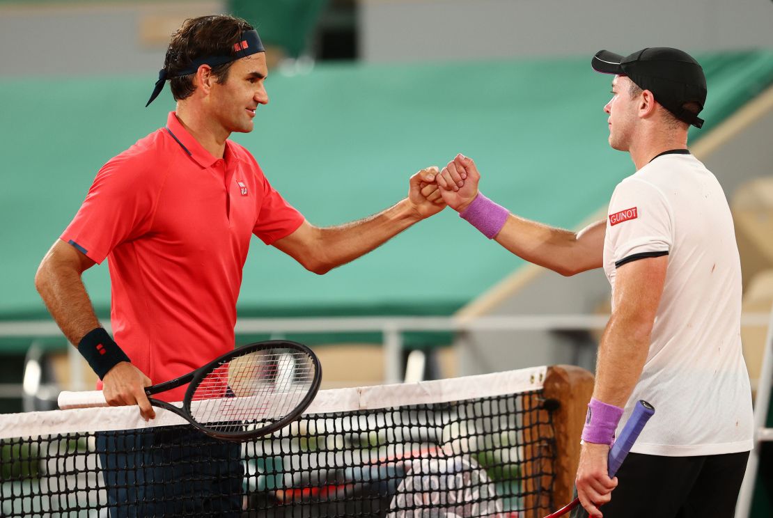 Federer shakes hands with Koepfer of Germany after winning their match early on Sunday morning.